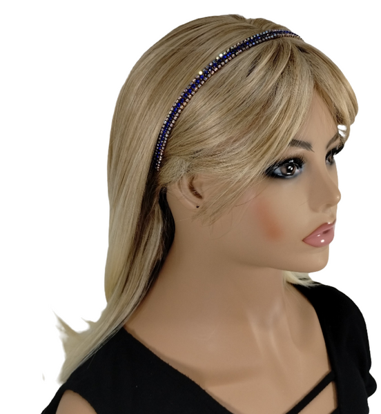 Mannequin head with blonde hair and a blue beaded headband on a white background