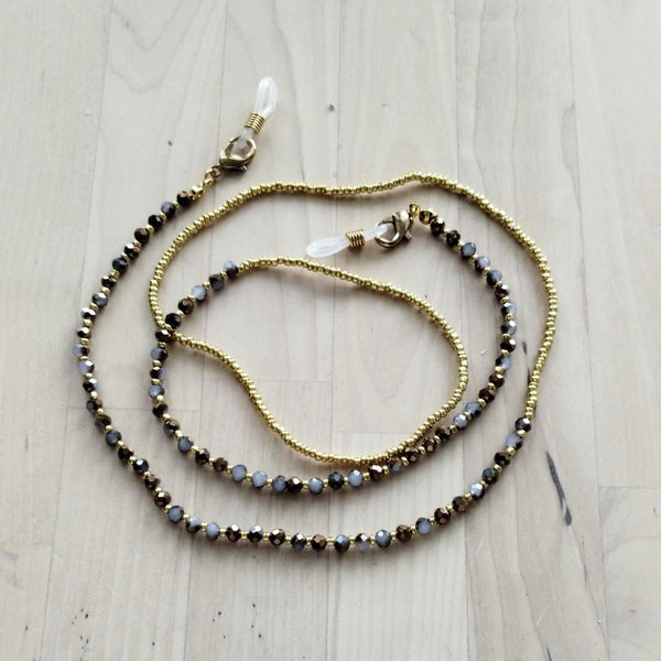 Handmade beaded eyeglass chain featuring sparkling glass beads in gold and purple, designed for stylish eyewear support.