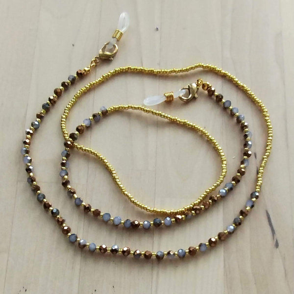 Handmade beaded eyeglass chain with sparkling gold and glass beads for stylish eyewear hold.