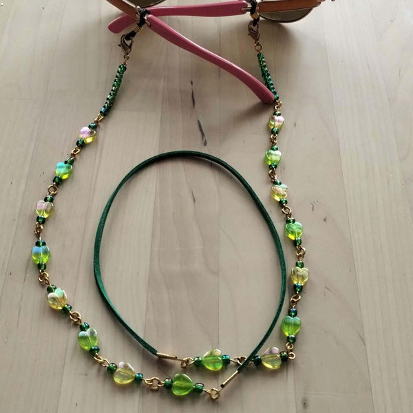 beaded eyeglasses holder with green and yellow beads attached to sunglasses. The middle part made from soft faux suede for comfort of your neck