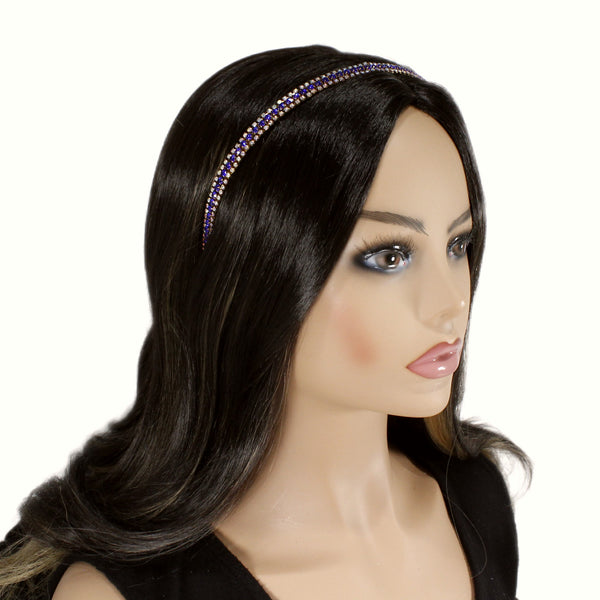 Mannequin head with long black hair wearing a decorative headband on a white background