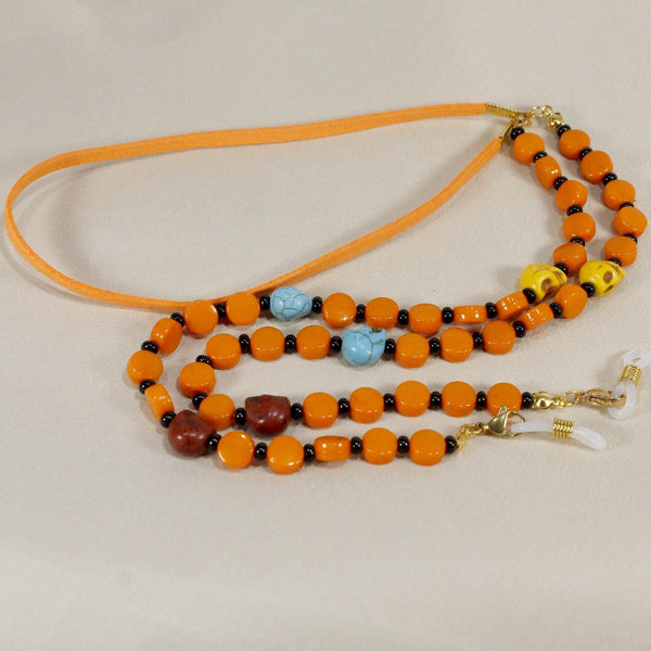 orange and black beads eyelasses holder adorned with stone skull beads. middle part made of fau suede cord, make it comfortable for the neck