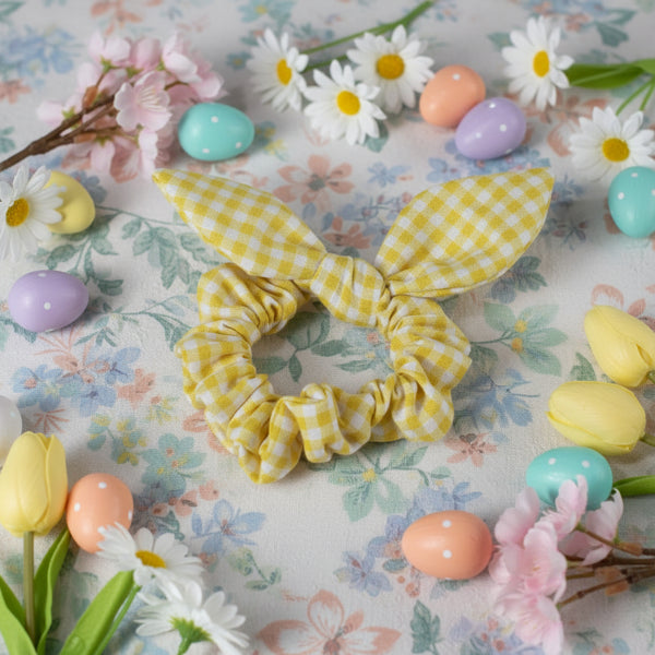 Yellow checkered scrunchie with bow on a white background
