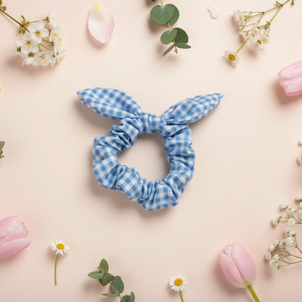 Blue checkered scrunchie with bunny ears on a green background
